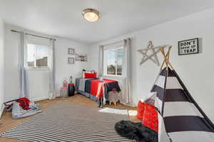 Carpeted bedroom with multiple windows