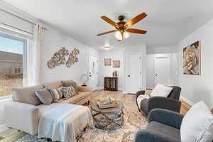 Living room featuring ceiling fan and light wood-type flooring