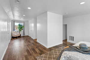 Bedroom with dark wood-type flooring