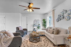 Living room with ceiling fan and wood-type flooring