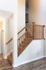 Staircase featuring wood-type flooring