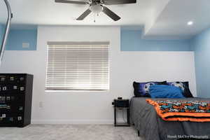 Carpeted bedroom with ceiling fan