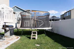 View of yard with a trampoline