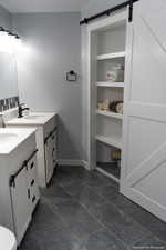 Bathroom featuring tile patterned floors and vanity