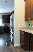 Laundry area featuring dark hardwood / wood-style floors