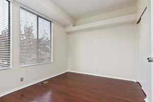 Spare room with dark hardwood / wood-style floors