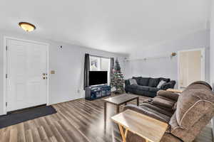 Living room with hardwood / wood-style flooring