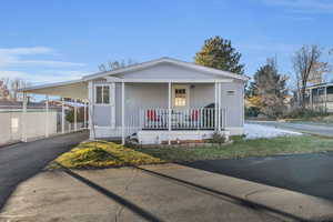 Manufactured / mobile home with covered porch and a carport