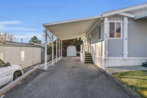 View of home's exterior with a shed and a carport