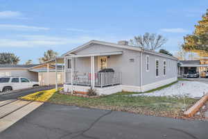 View of front of house featuring covered porch and a carport