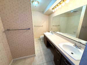 Bathroom featuring tile patterned floors, vanity, and toilet