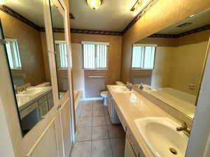 Bathroom featuring tile patterned floors, vanity, and toilet