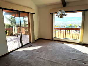 Unfurnished dining area featuring a mountain view, carpet, and plenty of natural light