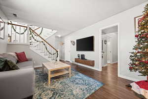 Living room with dark hardwood / wood-style flooring