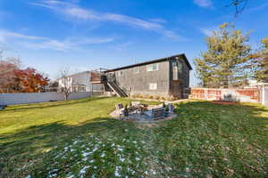 View of yard featuring a wooden deck and an outdoor fire pit