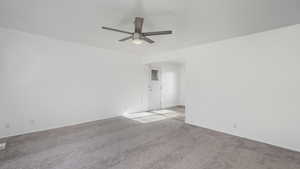 Spare room with ceiling fan and light carpet