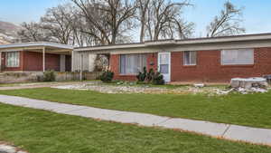 Ranch-style house with a front lawn