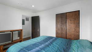 Bedroom with hardwood / wood-style floors and a closet