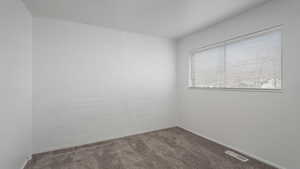 Empty room featuring carpet floors