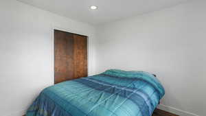 Bedroom featuring wood-type flooring and a closet