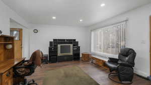 Office area with dark wood-type flooring and a wealth of natural light