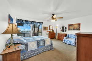 Bedroom featuring ceiling fan and carpet floors