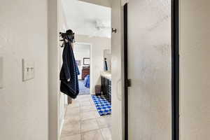 Bathroom featuring an enclosed shower, vanity, tile patterned floors, and ceiling fan