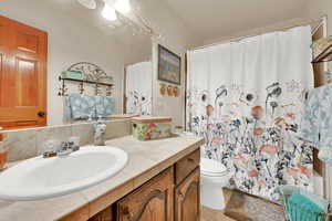 Bathroom with tile patterned flooring, vanity, and toilet