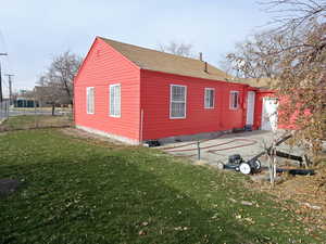 View of property exterior featuring a yard and a patio