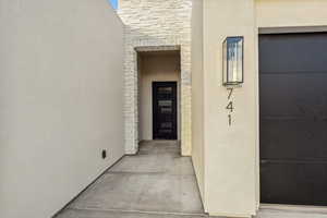 Property entrance with stucco siding and stone siding