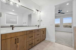 Full bath with recessed lighting, double vanity, ceiling fan, a sink, and baseboards