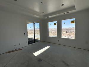 Unfurnished room featuring a raised ceiling