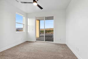 Spare room featuring baseboards, visible vents, ceiling fan, and carpet