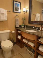Bathroom featuring tile patterned floors, vanity, and toilet