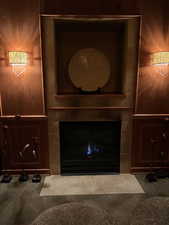 Details featuring a tile fireplace and carpet floors
