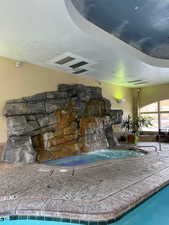 View of swimming pool featuring pool water feature
