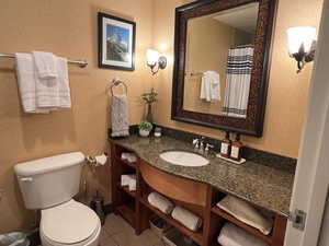 Bathroom with tile patterned floors, vanity, and toilet