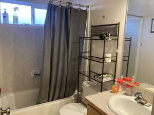 Full bathroom with vanity, toilet, and shower / tub combo