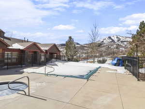 Snow covered pool with a mountain view