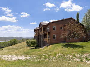 View of building exterior featuring a mountain view and central air condition unit