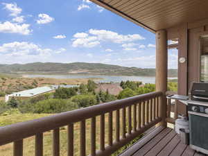 Wooden deck featuring a water and mountain view