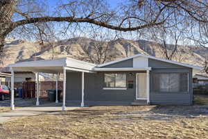 View of front of home with a mountain view and a carport