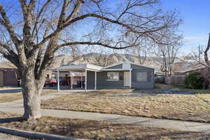 Ranch-style house with a carport and a mountain view