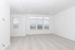 Empty room with light colored carpet and plenty of natural light