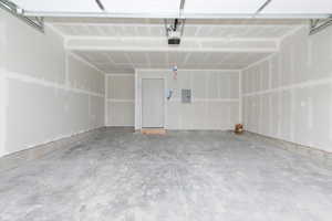 Garage with electric panel and a garage door opener