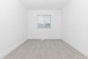 Unfurnished room with light colored carpet