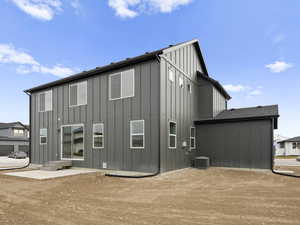 Rear view of property featuring a patio area and central air condition unit