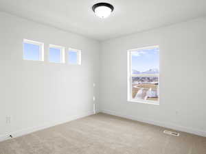 Carpeted spare room with a healthy amount of sunlight