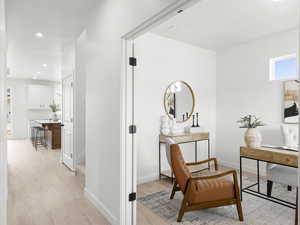 Hall with light hardwood / wood-style floors