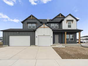 View of front of property featuring a porch and a garage